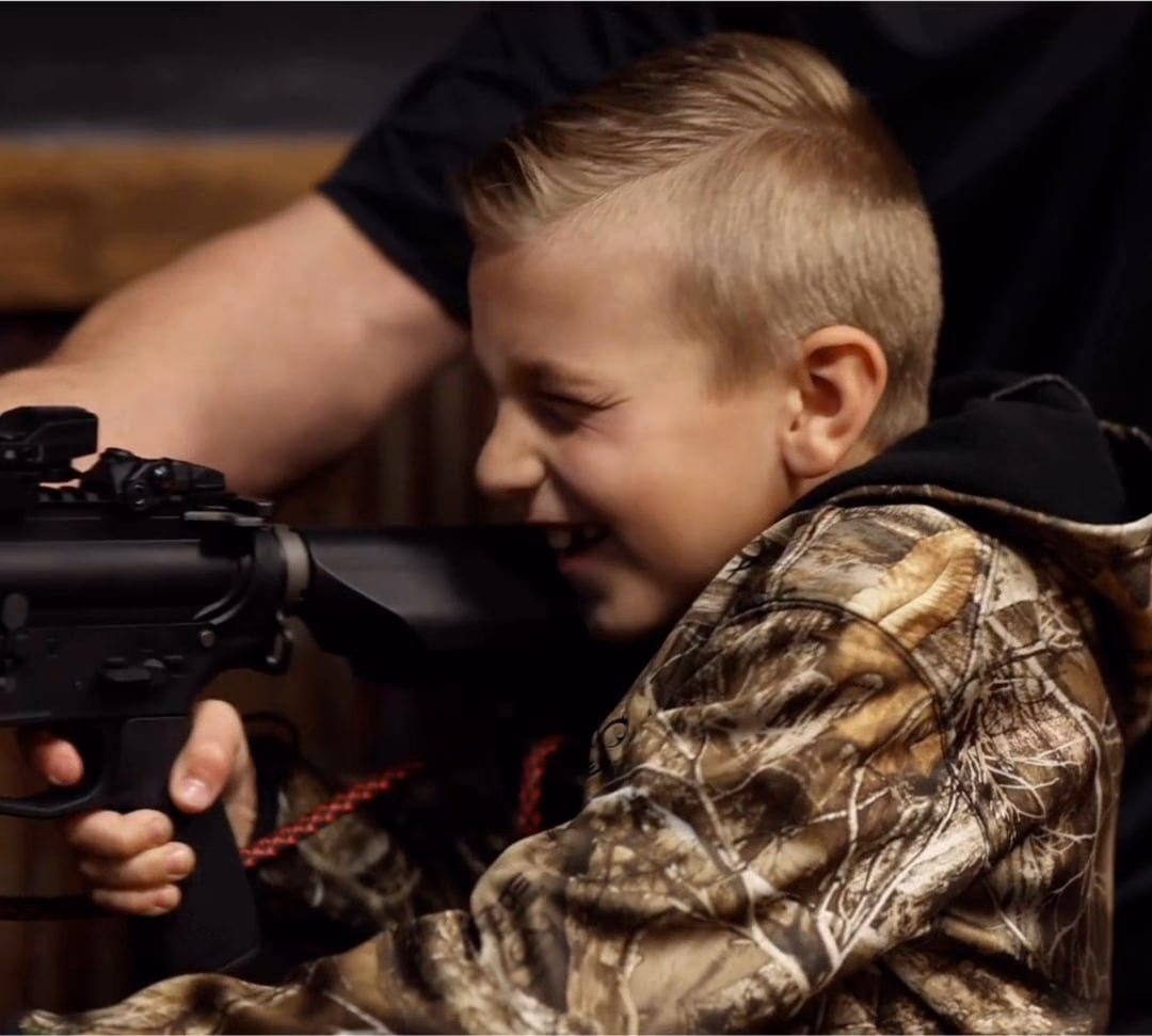 A young guest shooting at Top Shot, the family-friendly BB gun bar