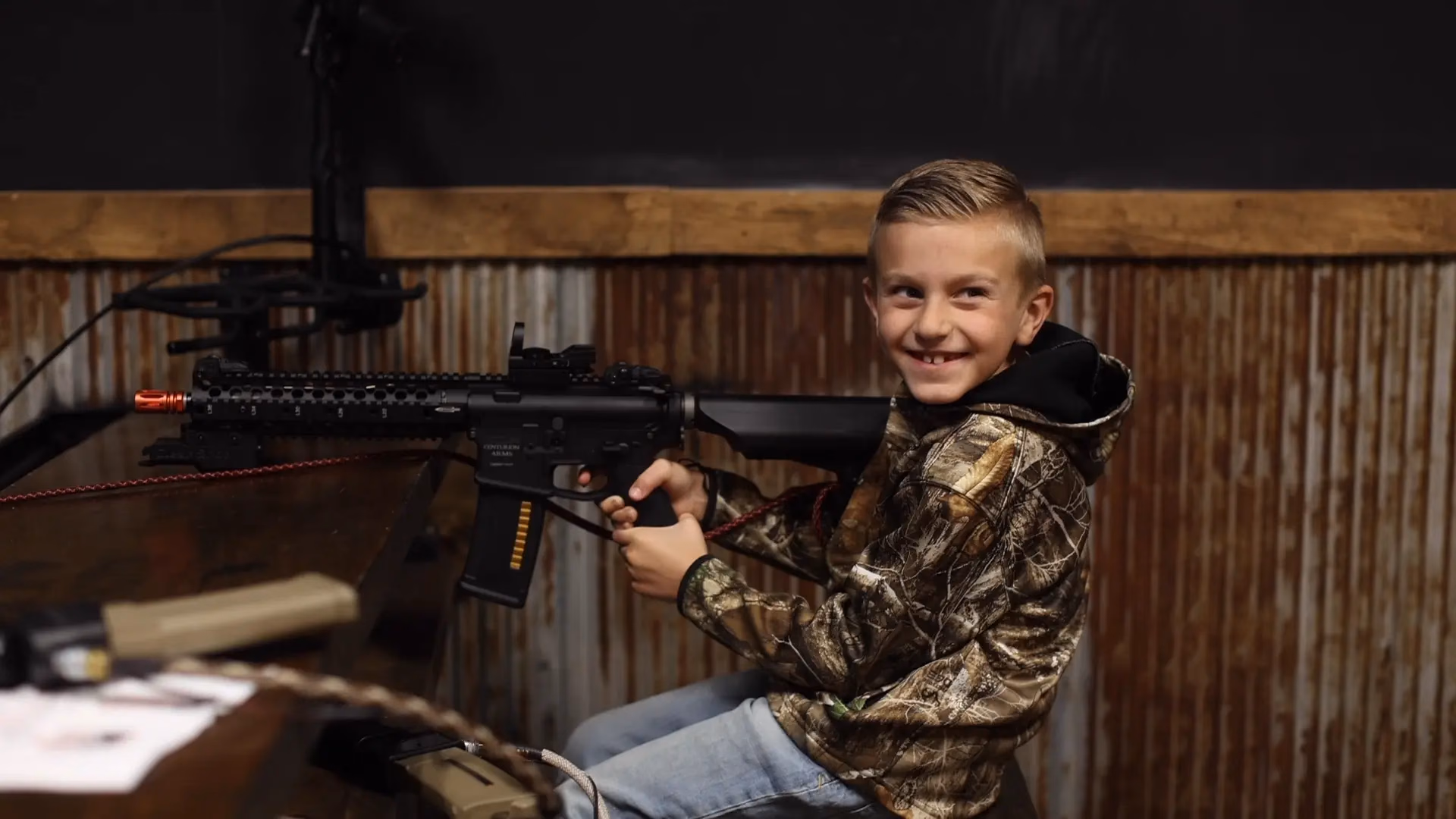 A guest taking aim with a BB rifle at Top Shot in St. Charles